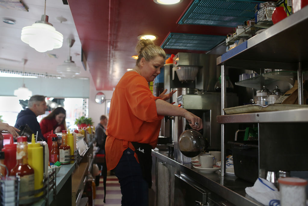 Lorie Hanselman pours coffee for customers